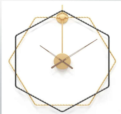 Geometric wall clock with black and gold design on a white background