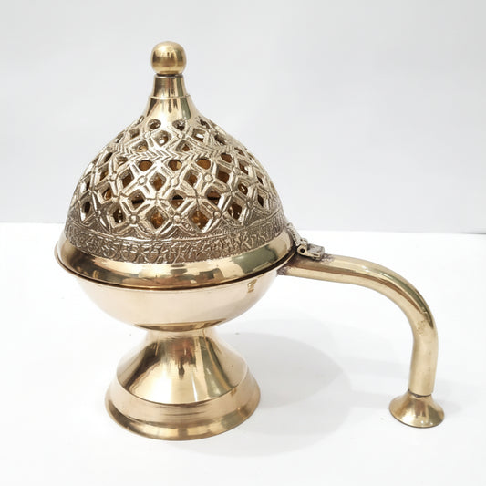 Brass incense burner with intricate design on a white background