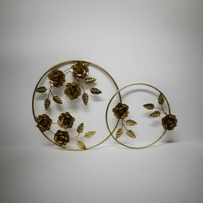Decorative wall art with gold floral design on a white background
