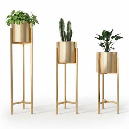 Three gold plant stands with plants against a neutral wall.