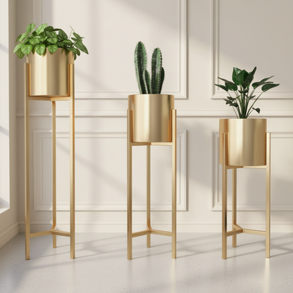 Three gold plant stands with potted plants against a neutral wall.