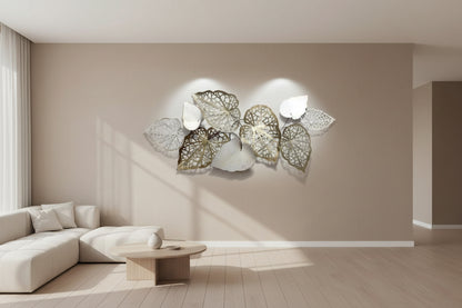 Decorative wall art with cut-out leaf designs on a plain background