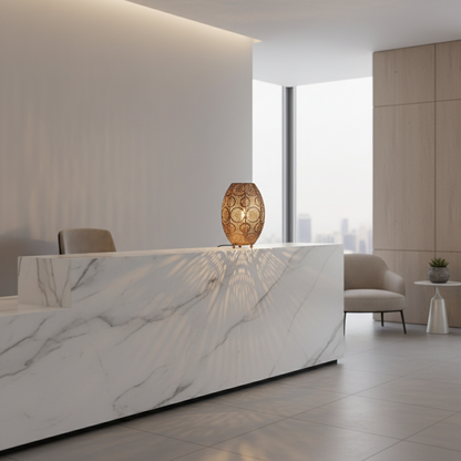 Modern interior with a marble reception desk and decorative lamp.