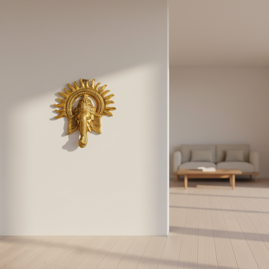 Modern interior with a gold wall sculpture and a sofa by large windows.