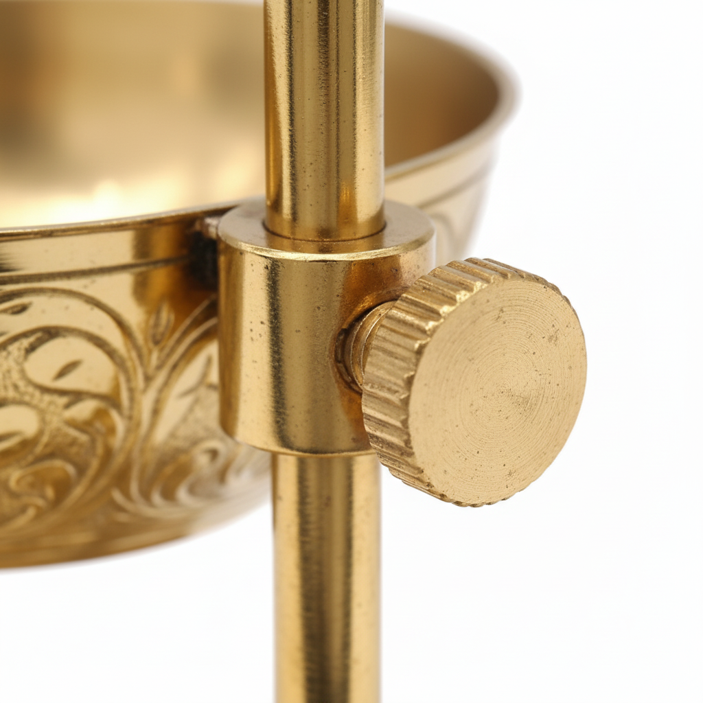 Close-up of a gold decorative item with intricate patterns on a white background