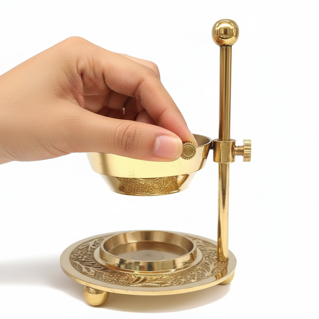 Gold decorative object with a hand interacting with it on a white background