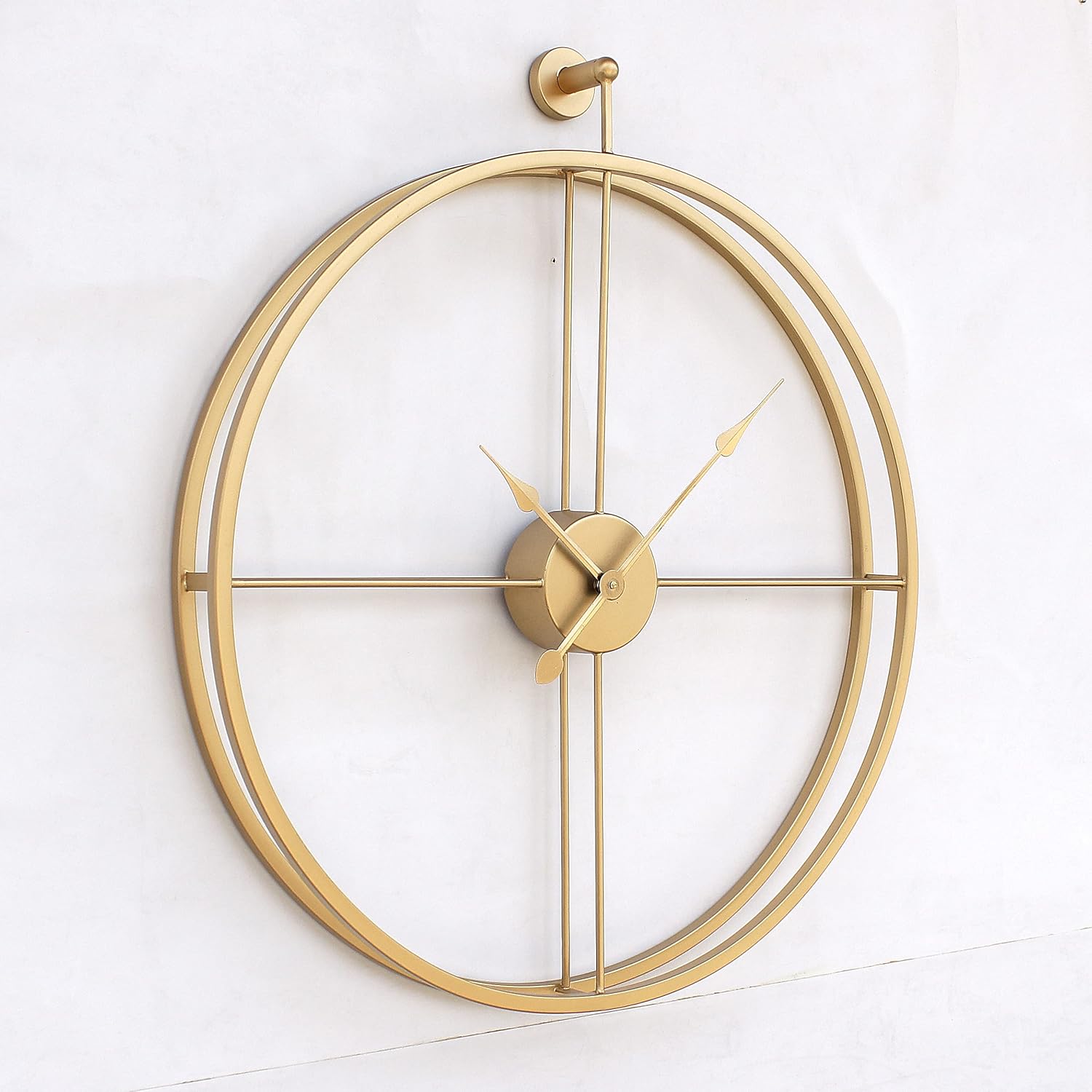 Gold wall clock with a modern design on a white background