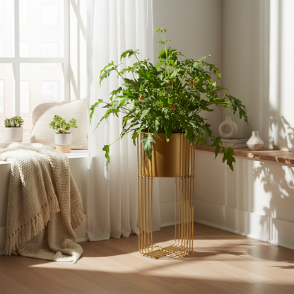 Gold plant stand with a potted plant in a bright room with white curtains.