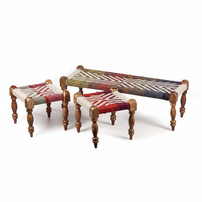 Set of three wooden stools with woven seat covers on a white background