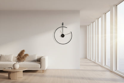 Modern wall clock with black frame and gold hands on a white background