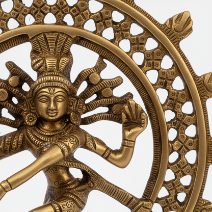 Bronze sculpture of a deity with a wheel-like structure on a white background