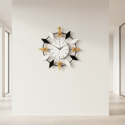 Modern wall clock with black and gold design on a white wall