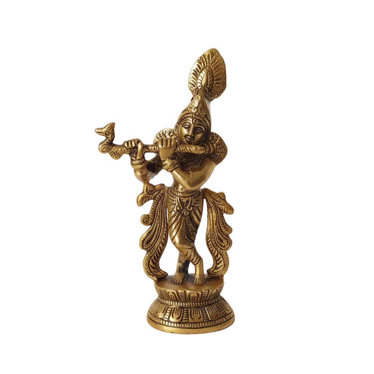 Gold-colored statue of a deity on a white surface