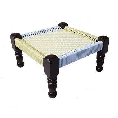 Small table with woven top and black legs on a white background