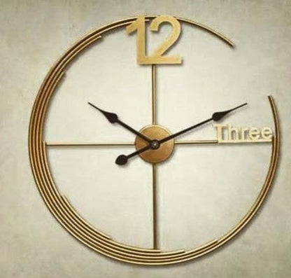 Gold wall clock with a unique design on a beige background