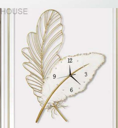 Decorative wall clock with feather design on a white background