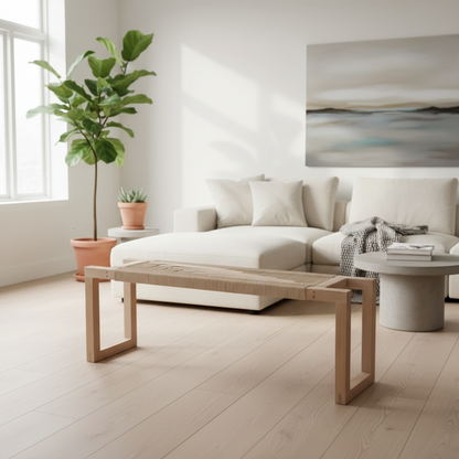 Modern living room with white sofa, wooden coffee table, and decorative plants.
