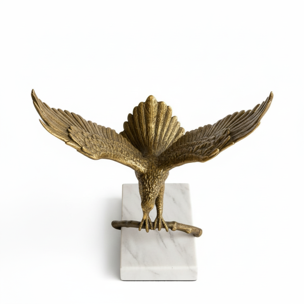Bronze eagle sculpture on a white marble base against a white background