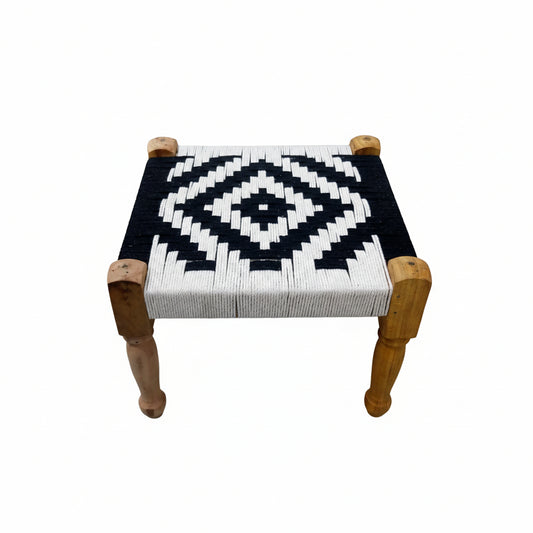 Small stool with a geometric pattern on a tiled floor