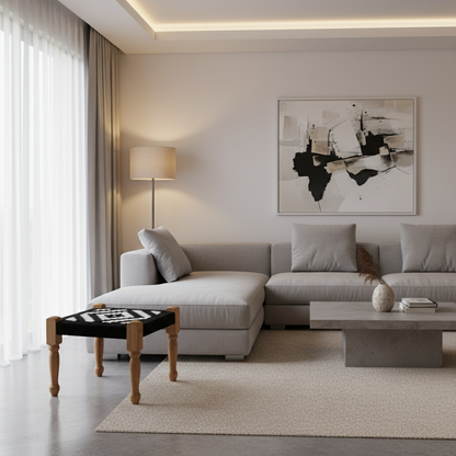 Modern living room with a gray sectional sofa, abstract art, and decorative items.