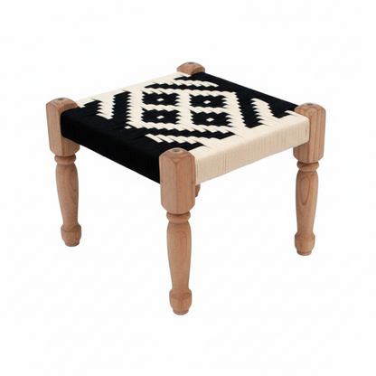 Small stool with black and white patterned seat on a white background