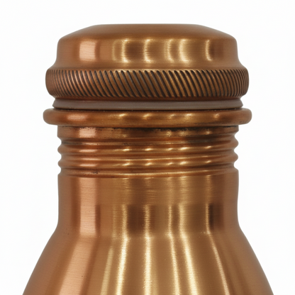 Close-up of a copper bottle cap on a white background