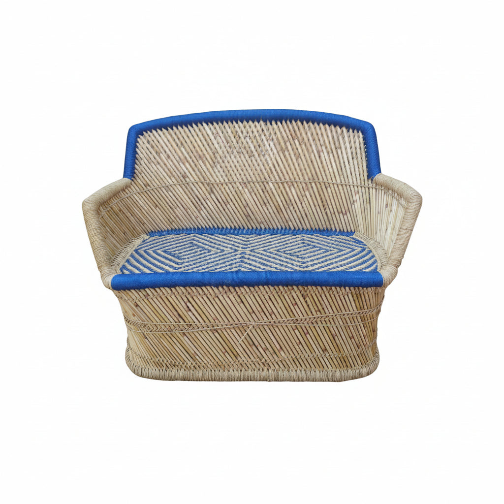 Wicker chair with blue cushions on a concrete floor