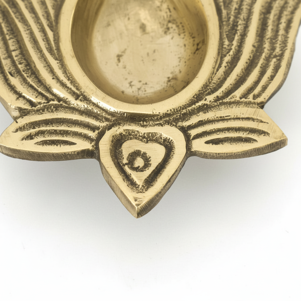 Brass decorative item with intricate patterns on a white background