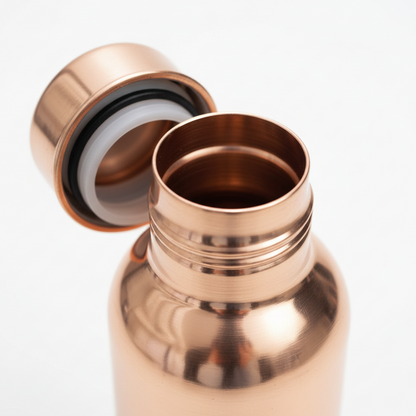Copper water bottle with lid on a white background