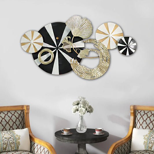 Decorative wall art pieces on a wall with chairs and a table below.