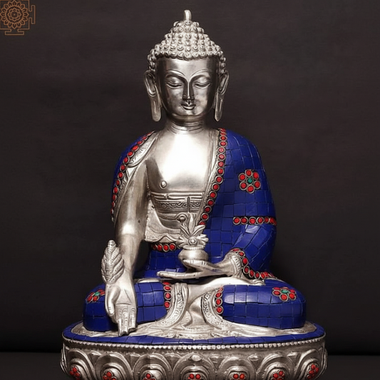 Silver and blue Buddha statue with red accents on a dark background