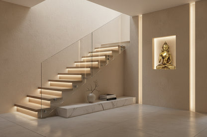 Gold-colored Buddha statue in a meditative pose on a white background
