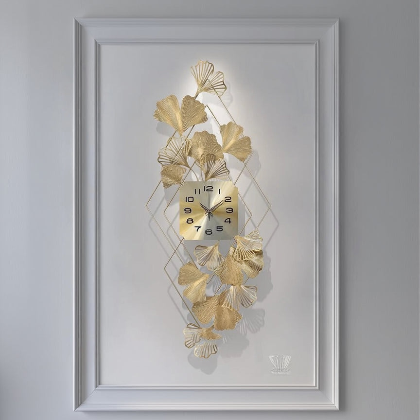 Decorative wall clock with gold leaf design on a white background