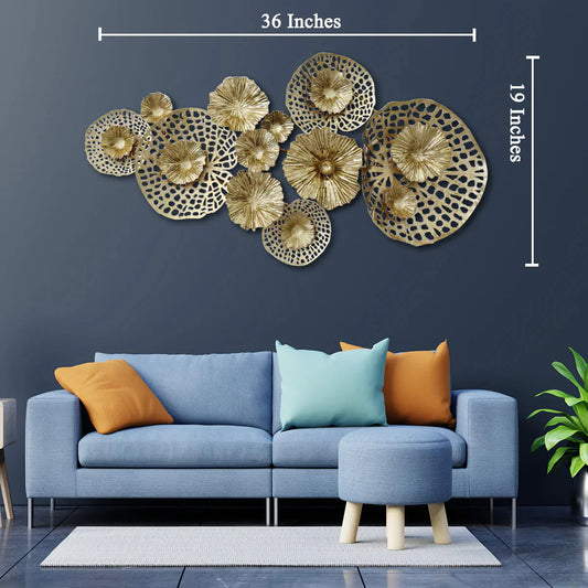 Decorative wall art with gold circular patterns above a blue sofa in a living room.