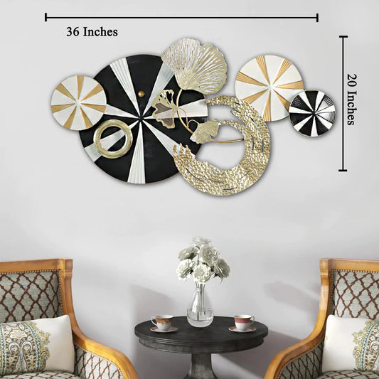 Decorative wall art with geometric designs in black, white, and gold on a white wall.