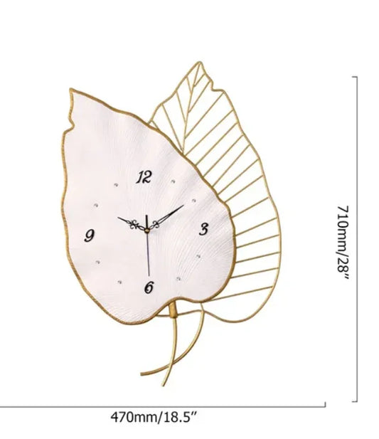 Decorative wall clock with leaf design and measurements on a white background