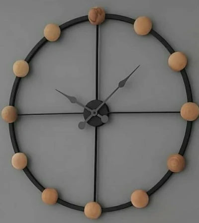 Decorative wall clock with wooden balls on a gray background