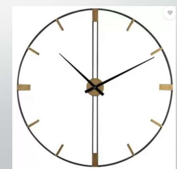 Round wall clock with black and gold design on a white background