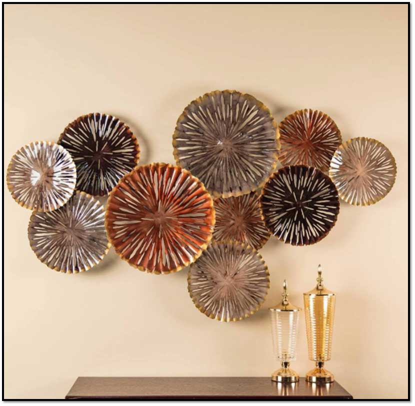 Decorative wall art with circular metal plates on a beige wall.