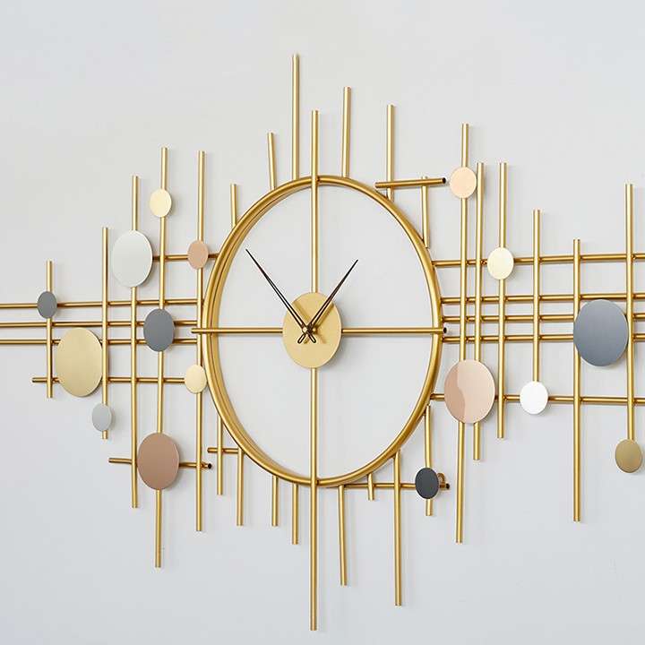 Decorative wall clock with gold and multicolor design on a light gray background