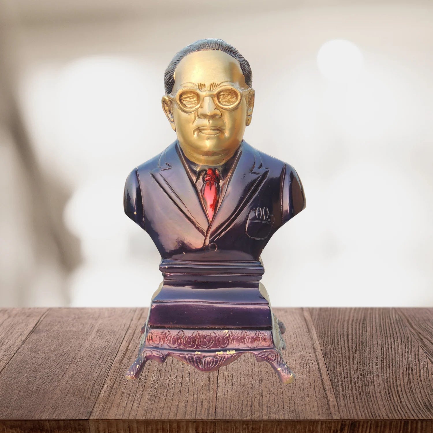 Bust of a man in formal attire on a wooden surface with a blurred background