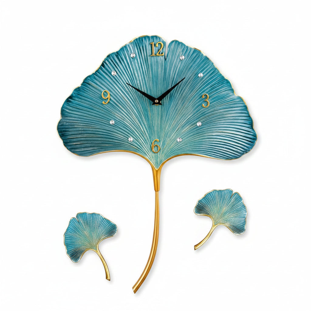 Decorative wall clock shaped like a blue ginkgo leaf with gold stem on a gray background