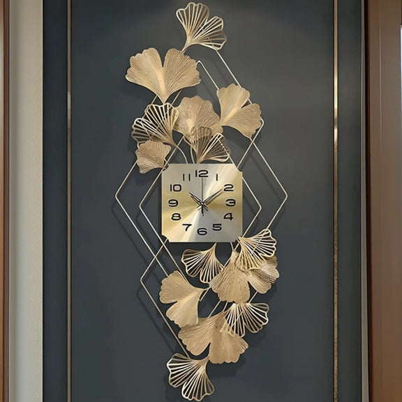 Decorative wall clock with gold leaf design on a dark background