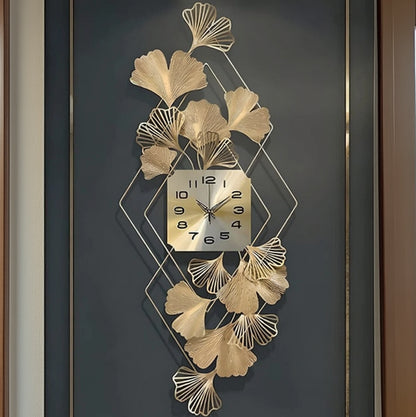 Decorative wall clock with gold leaf design on a dark background