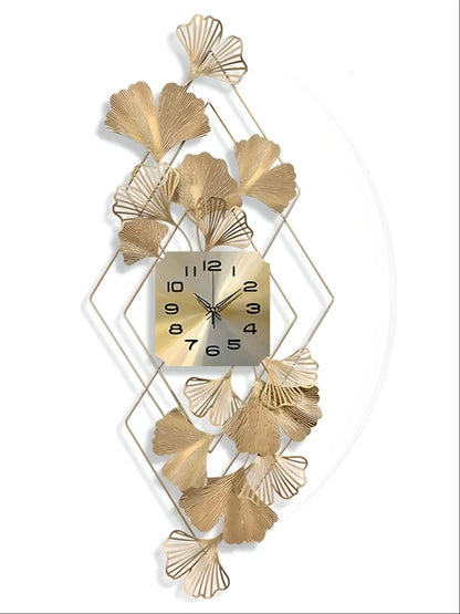 Decorative wall clock with gold leaf design on a white background