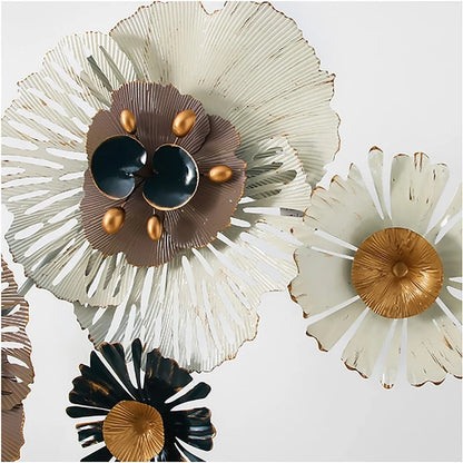 Decorative metal flowers in gold, black, and white on a light background