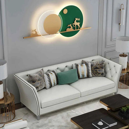 White sofa with decorative pillows in a living room setting, featuring a wall-mounted decorative piece.