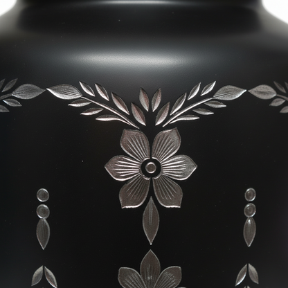 Black vase with floral engravings on a black background