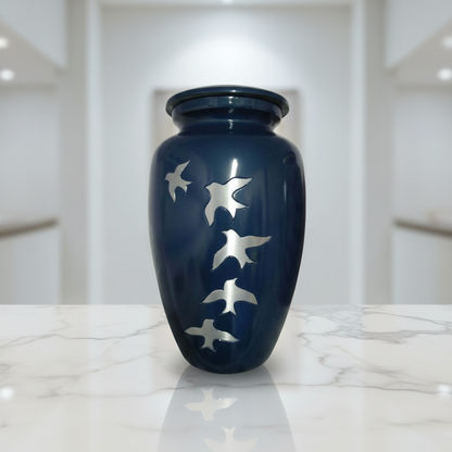 Blue urn with bird designs on a marble surface