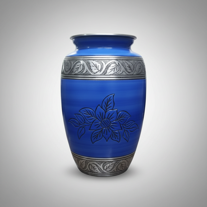 Blue urn with silver floral designs on a gray background